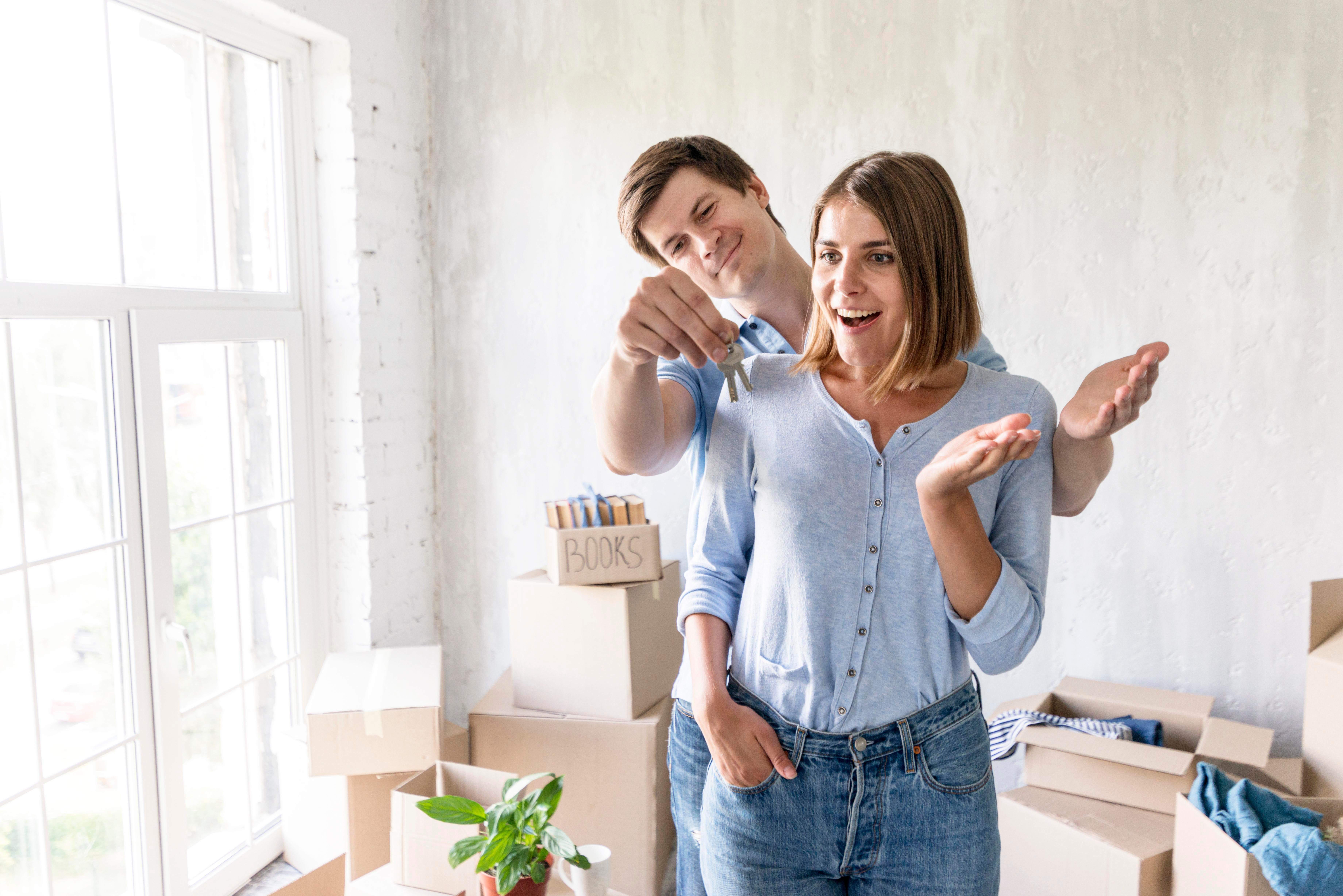 woman-surprised-by-partner-with-keys-their-new-home